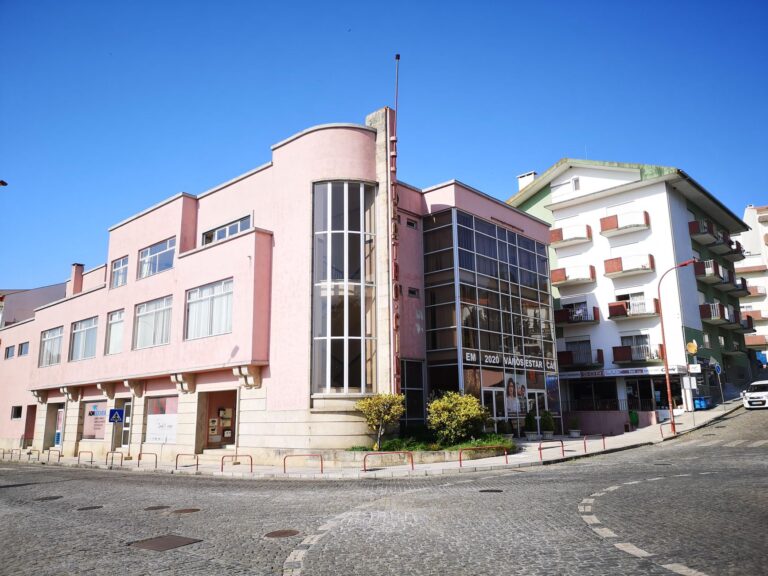 Art Deco style building in Gouveia, Portugal, showcasing vintage architecture on a sunny day.