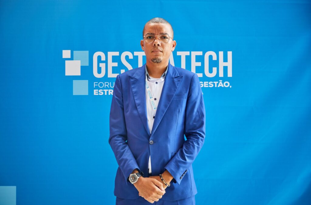 Confident businessman in blue suit at a professional conference event.