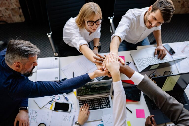 A group of professionals collaborating in a modern office, exemplifying teamwork and synergy.