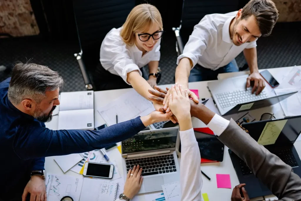 A group of professionals collaborating in a modern office, exemplifying teamwork and synergy.